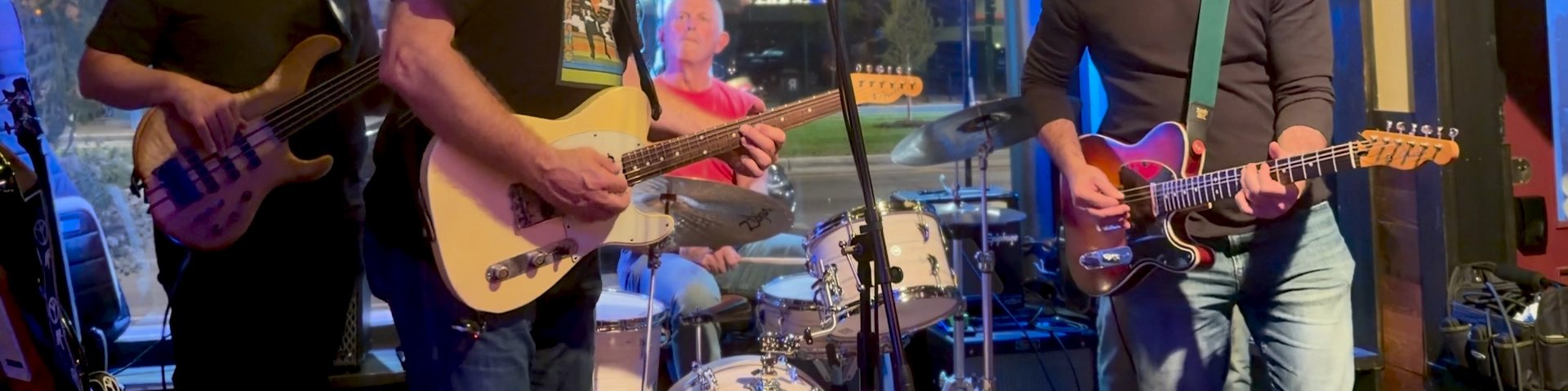 Close-up of the band’s bass, guitars and drum kit on stage