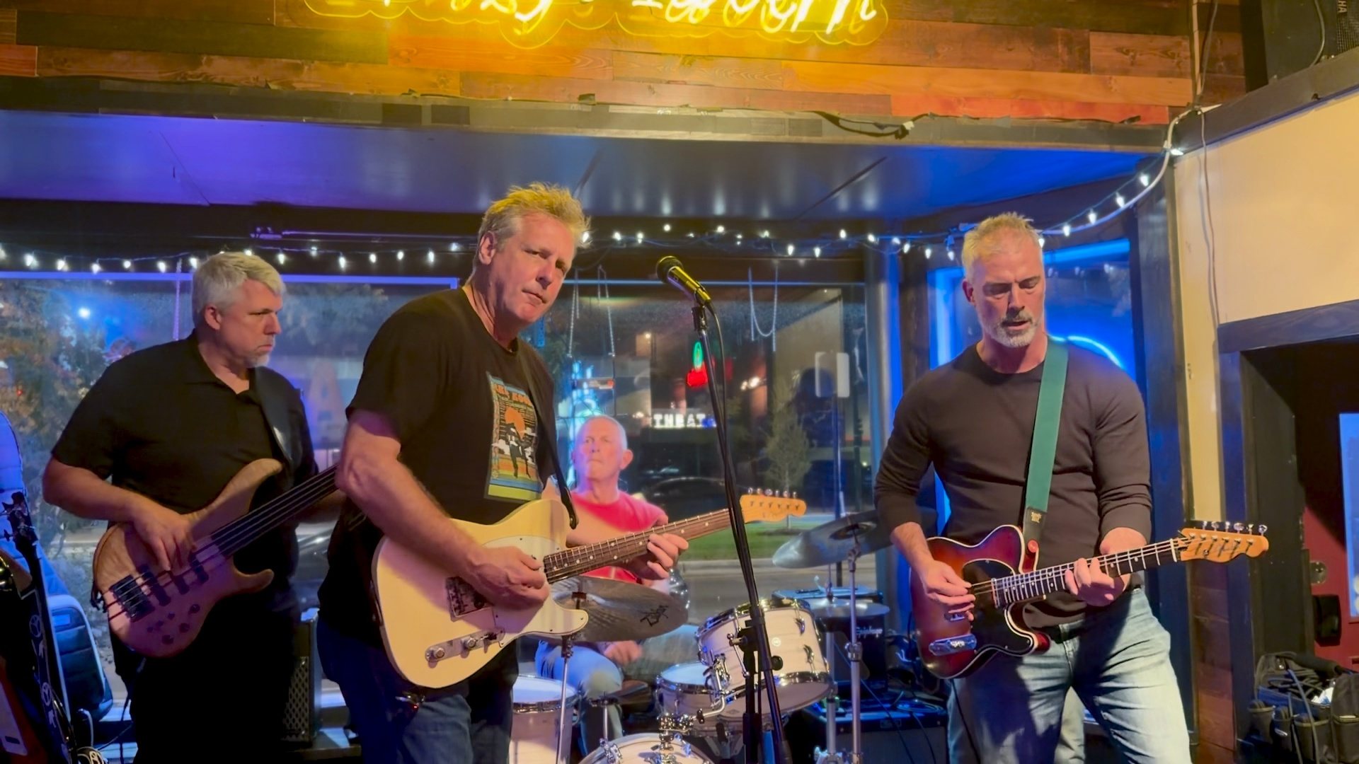 SoulTrippers on stage at Fritzy’s Tavern: bassist, two guitarists and drummer mid-song